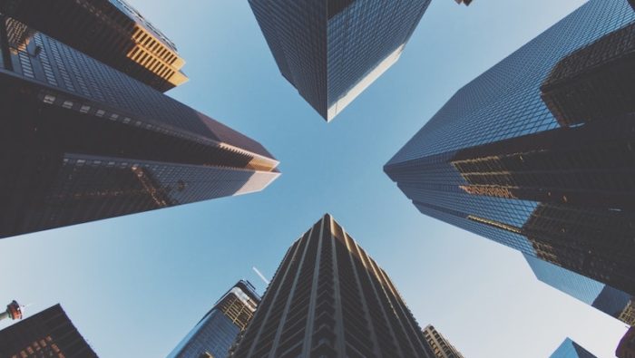 A photo of high rise city scape looking up from the ground