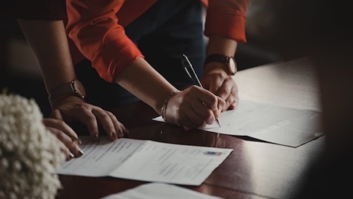 A photo of people signing a document