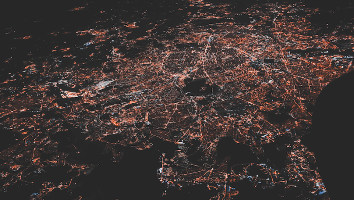 A satellite photo of electricity use above a city. Used under Unsplash License.