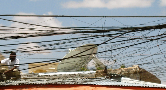 A photo of a man sitting with electricity wires, taken by Dr Stremlau during her fieldwork