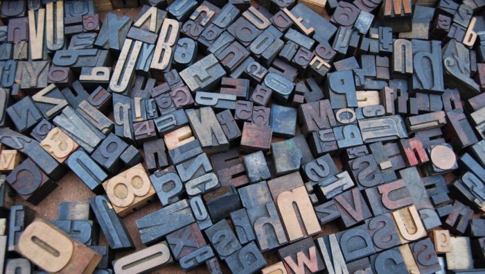 A photo of wooden letters cut out