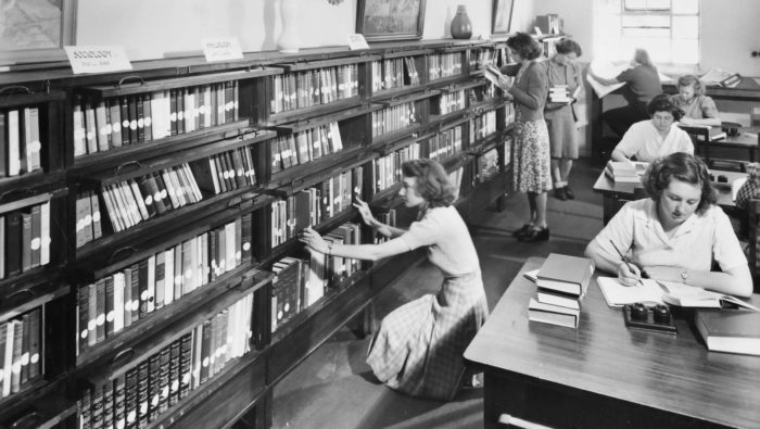 Black-and-white photograph of women in the Emily McPherson College Library in Melbourne, circa 1960s.