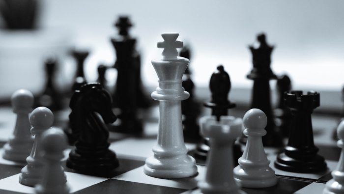 Black and white chess pieces on a chessboard.