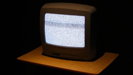 A vintage TV with static in the dark