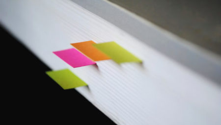 A book with coloured bookmarks sticking out