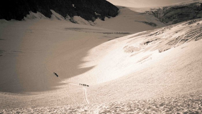 Persons walking a remote mountains