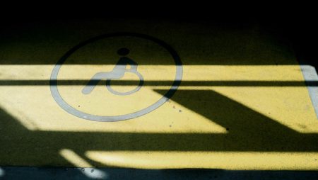 A photo of a yellow floor with a wheelchair symbol in black.