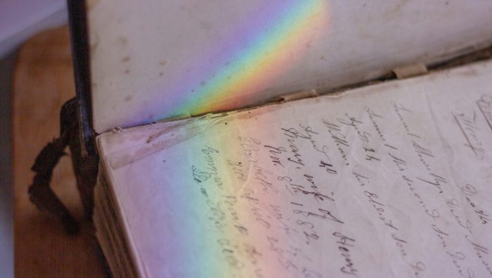 A rainbow on an old handwritten note book