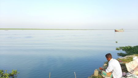 Nikli Haor in Kishoreganj, showing a local fisherman at work.